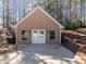 Detached brick garage featuring a double door entry with window and driveway at 2407 Honey Ct, Mcdonough, GA 30252