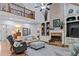 Open-concept living room under a vaulted ceiling with fireplace, built-in shelving, and hardwood floors at 2407 Honey Ct, Mcdonough, GA 30252