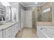 Bathroom suite featuring double vanity, soaking tub, and large glass shower at 2407 Honey Ct, Mcdonough, GA 30252