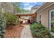 A stone walkway leads to a covered patio with a dining table and chairs at 2407 Honey Ct, Mcdonough, GA 30252