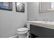 Elegant powder room with a pedestal sink and a modern toilet at 2407 Honey Ct, Mcdonough, GA 30252