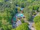 Aerial view of the community pool, clubhouse, and tennis courts surrounded by lush trees at 2885 Arborwoods Dr, Alpharetta, GA 30022
