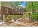 Charming backyard with a multi-level deck, lush landscaping, and a serene fountain at 2885 Arborwoods Dr, Alpharetta, GA 30022