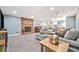 Relaxing basement featuring gray sectional, brick fireplace, and recessed lighting at 2885 Arborwoods Dr, Alpharetta, GA 30022