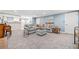 Spacious basement featuring gray sectional sofa, wet bar, and neutral carpeting at 2885 Arborwoods Dr, Alpharetta, GA 30022