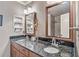 Bathroom featuring a double vanity with granite countertops and framed mirrors at 2885 Arborwoods Dr, Alpharetta, GA 30022