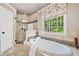 Bright bathroom featuring a soaking tub, a glass enclosed shower and window views at 2885 Arborwoods Dr, Alpharetta, GA 30022