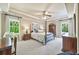 Charming bedroom with tray ceiling, neutral colors, carpet, windows for natural light, and a four-poster bed at 2885 Arborwoods Dr, Alpharetta, GA 30022