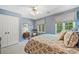 Blue bedroom features a patterned bedspread and natural light from the window at 2885 Arborwoods Dr, Alpharetta, GA 30022