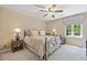 Neutral bedroom featuring a metal bed frame and a view of nature from the window at 2885 Arborwoods Dr, Alpharetta, GA 30022