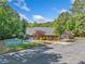 Community clubhouse with basketball court and ample parking, surrounded by lush trees at 2885 Arborwoods Dr, Alpharetta, GA 30022