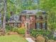 Charming two-story brick home with manicured landscaping and a welcoming front entrance at 2885 Arborwoods Dr, Alpharetta, GA 30022