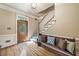 Inviting foyer featuring hardwood floors, staircase, decorative bench, and stained glass front door at 2885 Arborwoods Dr, Alpharetta, GA 30022