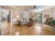 Spacious living room with hardwood floors, ceiling fan, neutral paint colors, and abundant natural light from the window at 2885 Arborwoods Dr, Alpharetta, GA 30022