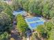 Aerial view of the community tennis courts with lush greenery and shaded seating areas at 2885 Arborwoods Dr, Alpharetta, GA 30022