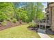 Beautiful backyard with a wooden deck, mature trees and green grass at 330 Plantation Way, Roswell, GA 30075