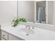 Close-up of a bathroom vanity with a white countertop, basin sink, and a large mirror, highlighting modern fixtures at 330 Plantation Way, Roswell, GA 30075