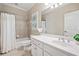 Bathroom featuring a shower-tub combo, neutral tile and white vanity with decorative shrub at 330 Plantation Way, Roswell, GA 30075