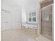 Bright bathroom with a tiled shower, soaking tub, and neutral color palette creating a relaxing retreat at 330 Plantation Way, Roswell, GA 30075