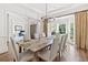 Elegant dining room with bay window, hardwood floors, and sophisticated chandelier at 330 Plantation Way, Roswell, GA 30075