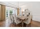 Dining room featuring hardwood floors, bay windows, and elegant chandelier lighting at 330 Plantation Way, Roswell, GA 30075