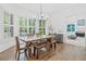 Dining room features natural lighting, with hardwood floors, and an access to an adjacent living space at 330 Plantation Way, Roswell, GA 30075