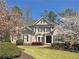 Attractive two-story home with well-kept lawn, complemented by blooming trees adding charm and curb appeal at 330 Plantation Way, Roswell, GA 30075
