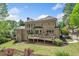 Beautiful home featuring a brick exterior, a wooden deck, and lush greenery at 330 Plantation Way, Roswell, GA 30075