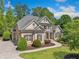 Charming two-story home featuring manicured landscaping, a curved walkway, and a blend of brick and siding accents at 330 Plantation Way, Roswell, GA 30075