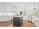 Elegant eat-in kitchen with stainless steel appliances, center island, white cabinets, and hardwood flooring at 330 Plantation Way, Roswell, GA 30075