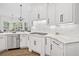 Kitchen with stainless steel appliances, stone countertops, white cabinets and hardwood flooring at 330 Plantation Way, Roswell, GA 30075