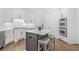 Bright kitchen features a center island, stainless steel appliances, custom white cabinets, and a breakfast bar at 330 Plantation Way, Roswell, GA 30075