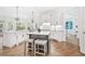 Modern kitchen features a center island, stainless steel appliances, white cabinets, and hardwood floors at 330 Plantation Way, Roswell, GA 30075