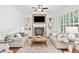 Bright living room with fireplace, built-in shelving, hardwood floors, and two sofas at 330 Plantation Way, Roswell, GA 30075