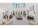 Bright living room featuring tall windows, fireplace, and neutral décor, perfect for relaxation and entertaining at 330 Plantation Way, Roswell, GA 30075