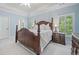 Spacious main bedroom featuring a four-poster bed, light blue walls and plantation shutters at 330 Plantation Way, Roswell, GA 30075