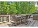 Exterior deck featuring dining and lounge seating areas surrounded by lush trees at 330 Plantation Way, Roswell, GA 30075