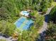 Aerial shot of neighborhood tennis courts and community pool surrounded by mature trees, offering resort-style amenities at 330 Plantation Way, Roswell, GA 30075