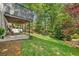 Spacious backyard with a covered patio and lush green lawn at 3585 Legacy Trce, Alpharetta, GA 30022
