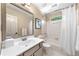 Well-lit bathroom with a combined tub and shower, large mirror, and neutral decor at 3585 Legacy Trce, Alpharetta, GA 30022