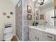 Half-bathroom with stylish wallpaper, modern vanity, and decorative accents at 3585 Legacy Trce, Alpharetta, GA 30022