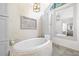 Spa bathroom features a large tub with luxurious fixtures and bright lighting at 3585 Legacy Trce, Alpharetta, GA 30022