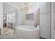 Spa bathroom features a large tub with luxurious fixtures and bright lighting at 3585 Legacy Trce, Alpharetta, GA 30022