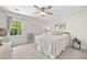 Cozy bedroom with ceiling fan and large window bringing in lots of natural light at 3585 Legacy Trce, Alpharetta, GA 30022