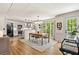 Open dining area with hardwood floors and views into the kitchen and out to the yard at 3585 Legacy Trce, Alpharetta, GA 30022