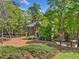 Beautiful brick home with well-maintained lawn and mature trees, creating a serene setting at 3585 Legacy Trce, Alpharetta, GA 30022