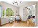 Inviting foyer with hardwood floors, arched window, and comfortable seating area at 3585 Legacy Trce, Alpharetta, GA 30022