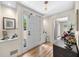 Bright foyer with hardwood floors, a large front door, and views into the home at 3585 Legacy Trce, Alpharetta, GA 30022