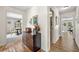 Spacious hallway with hardwood floors and views of the dining room and other living spaces at 3585 Legacy Trce, Alpharetta, GA 30022