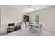 Bright home office featuring a glass desk, modern shelving, and a ceiling fan at 3585 Legacy Trce, Alpharetta, GA 30022